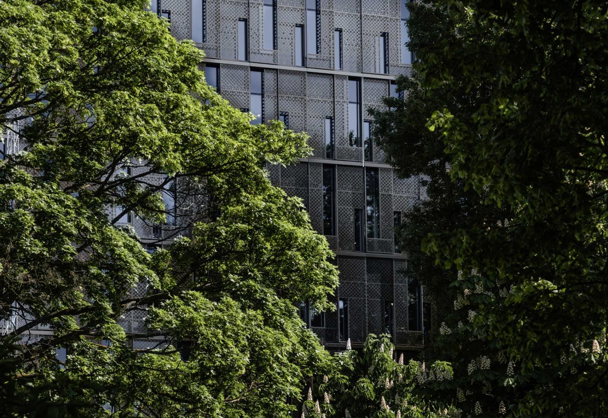 Green trees in front of house facade