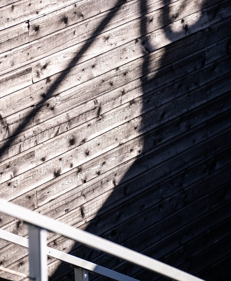 Shadow of stair railing on wood